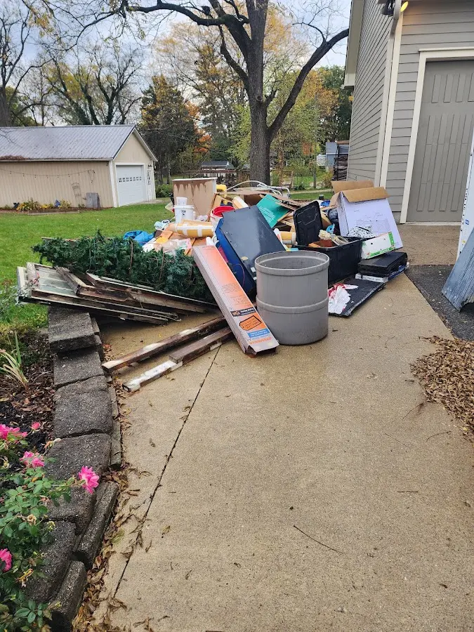 Dumpster being loaded with debris for Estate Cleanout Dumpster Rental in Bulverde